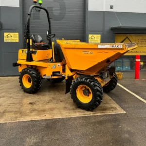 Yellow site dumper parked outside a tool hire depot