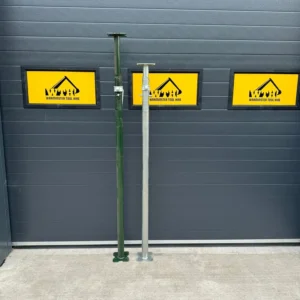 Two adjustable steel props standing in front of Warminster Tool Hire signs