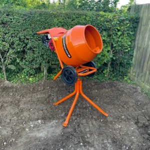 Orange cement mixer on a stand in a garden