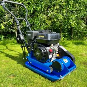 Plate compactor on grass with a petrol engine and handle