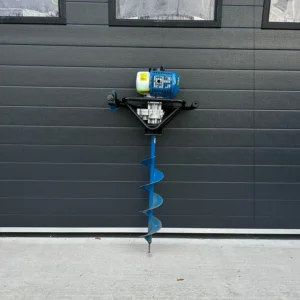 Petrol earth auger with blue drill bit mounted against a grey wall
