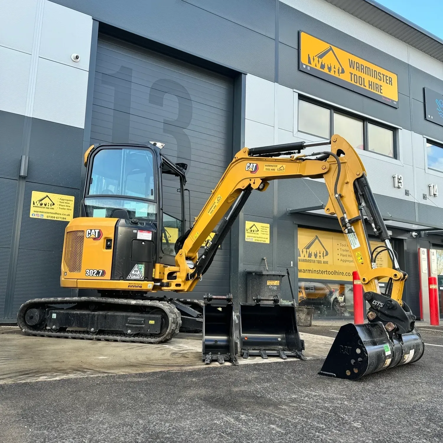 Yellow CAT mini excavator outside Warmister Tool Hire depot