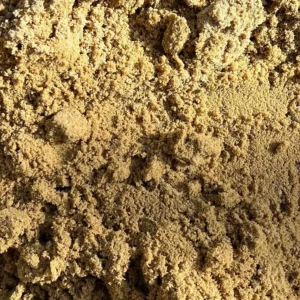 Close-up of coarse sand with small clumps and grains
