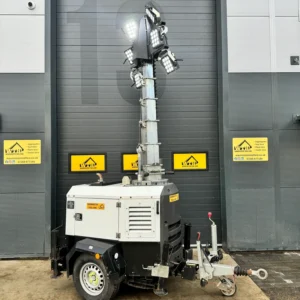 Mobile lighting tower on a trailer with multiple floodlights, parked outside Warminster Tool Hire